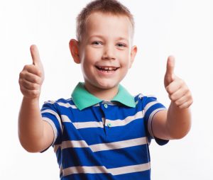 Portrait of happy boy showing thumbs up