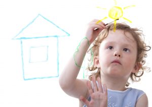 Little girl drawing on glass